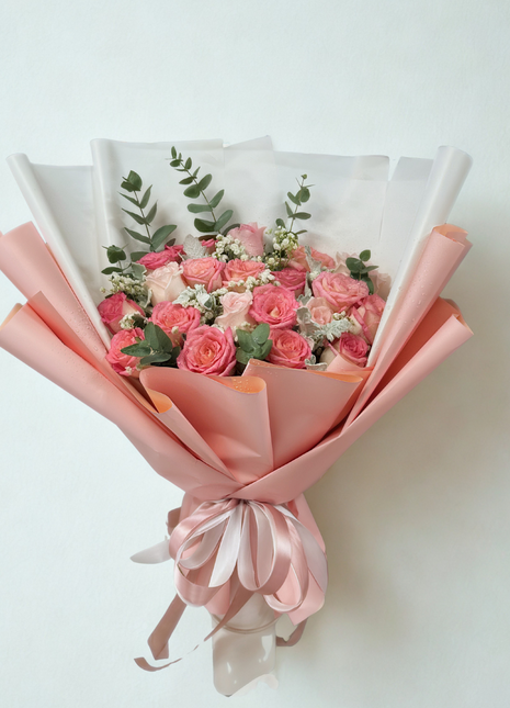 Elegant coral and pink roses bouquet with eucalyptus in white coral wrapping - fresh flower delivery Bangkok | DP FLOWERS BANGKOK