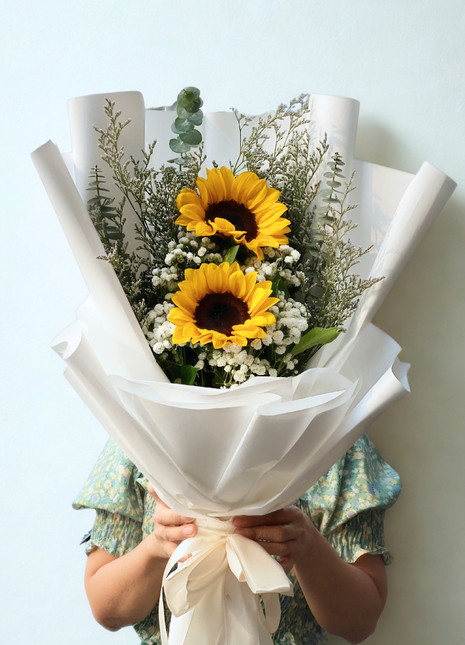 Fresh sunflower bouquet with baby's breath and eucalyptus in white wrapping - cheerful flower delivery Bangkok | DP FLOWERS BANGKOK