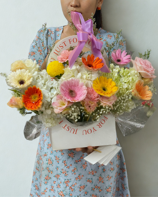 Happy woman holding a beautiful bouquet from DP FLOWERS BANGKOK – real customer review, surprised with flower delivery