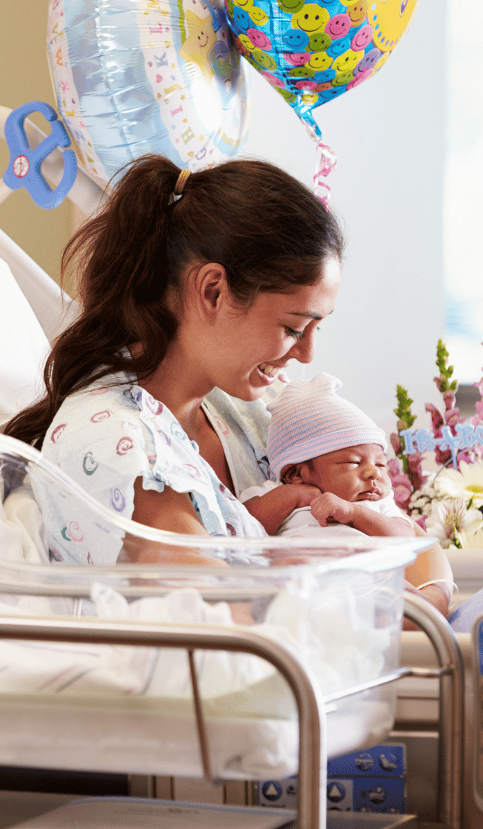 Happy new mom holding newborn baby – DP FLOWERS BANGKOK new born flower delivery to hospitals