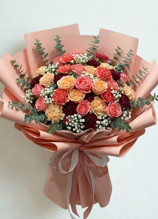 Vibrant coral pink roses and golden yellow carnations bouquet with burgundy carnations wrapped in dusty rose paper grand size- colorful flower delivery Bangkok | DP FLOWERS BANGKOK