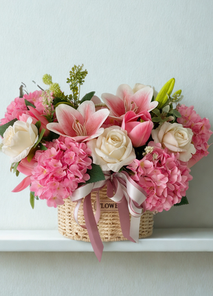 Elegant artificial flower basket with pink lilies, cream roses and pink hydrangeas in natural woven basket with ribbon - permanent décor Bangkok | DP FLOWERS BANGKOK