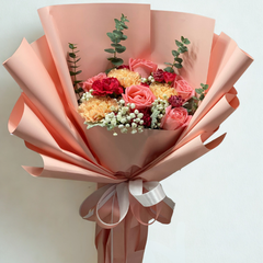 Vibrant coral pink roses and golden yellow carnations bouquet with burgundy carnations wrapped in dusty rose paper - colorful flower delivery Bangkok | DP FLOWERS BANGKOK
