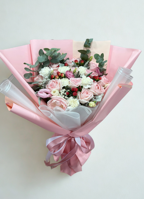 Elegant pink roses white carnations and red hypericum berries bouquet with eucalyptus in pink white wrapping - luxury flower delivery Bangkok | DP FLOWERS BANGKOK