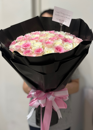 A large, luxurious bouquet of 50 two-tone pink and white roses wrapped in dramatic black paper with a pink and white ribbon - Proposal/Grand Gesture flower delivery Bangkok | DP FLOWERS BANGKOK