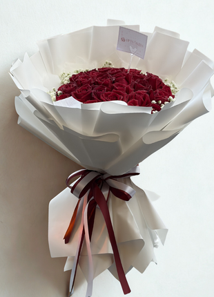 Grand bouquet of 30 premium deep red roses with baby's breath wrapped in white paper with burgundy satin ribbon - romantic flower delivery Bangkok | DP FLOWERS BANGKOK