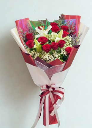 Passionate red roses and white lilies bouquet wrapped in red-white holographic paper - romantic flower delivery Bangkok | DP FLOWERS BANGKOK