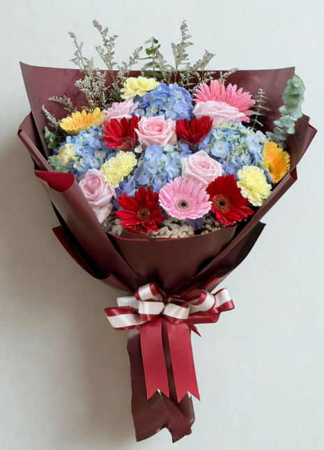 Romantic mixed flowers bouquet wrapped in burgundy paper with burgundy ribbons - unique flower delivery Bangkok | DP FLOWERS BANGKOK