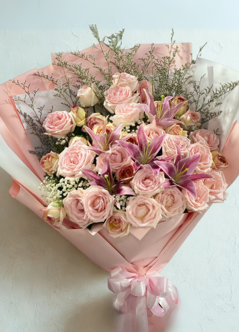 Elegant pink roses and lilies bouquet with baby's breath in pink wrapping - luxury flower delivery Bangkok | DP FLOWERS BANGKOK