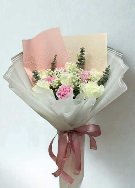 Elegant white roses and pink carnations bouquet with baby's breath wrapped in white gradient paper - serene flower delivery Bangkok | DP FLOWERS BANGKOK