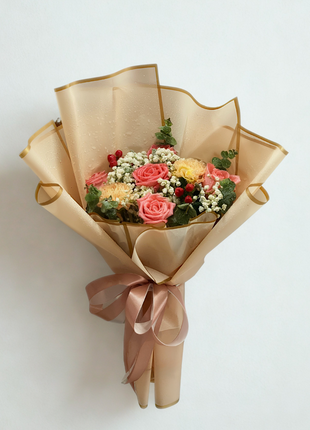 Cheerful coral pink roses and yellow carnations bouquet with berries wrapped in champagne gold paper - sunny flower delivery Bangkok | DP FLOWERS BANGKOK