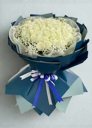 Grand luxury bouquet with 50 premium white roses and baby's breath wrapped in navy blue paper with white tulle - luxury flower delivery Bangkok | DP FLOWERS BANGKOK