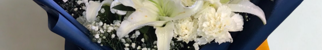 White Oriental lilies roses and carnations bouquet with baby's breath in navy blue wrapping - peaceful flower delivery Bangkok | DP FLOWERS BANGKOK