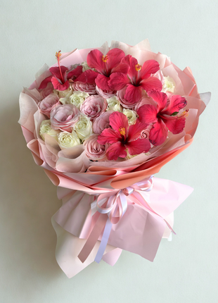 Elegant pink and white roses bouquet with vibrant hibiscus blooms wrapped in blush pink paper with satin ribbon - flower delivery Bangkok | DP FLOWERS BANGKOK