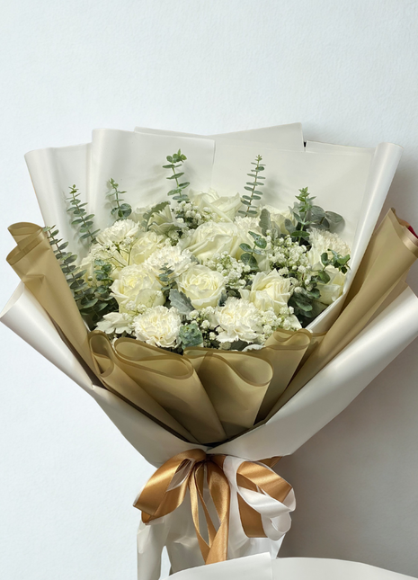 Luxury white roses and white carnations bouquet with eucalyptus wrapped in gold and white paper - elegant flower delivery Bangkok | DP FLOWERS BANGKOK