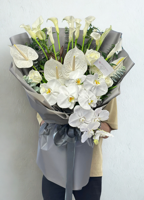 Luxury white calla lilies, anthuriums and phalaenopsis orchids bouquet wrapped in silver grey satin paper with grey ribbon - premium flower delivery Bangkok | DP FLOWERS BANGKOK