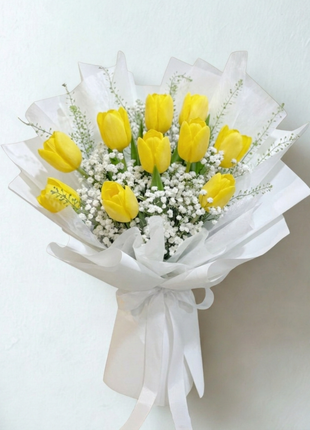 Bright yellow tulips bouquet with white baby's breath wrapped in crisp white paper with satin ribbon - flower delivery Bangkok | DP FLOWERS BANGKOK