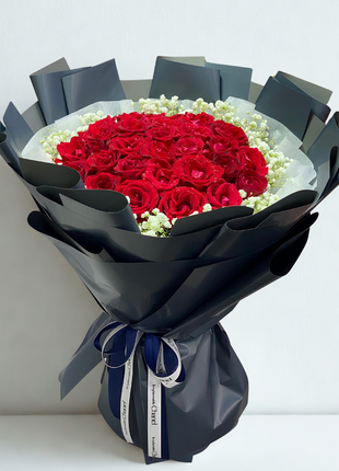 Luxury deep red roses bouquet with white baby's breath in elegant black wrapping with navy ribbon - premium flower delivery Bangkok | DP FLOWERS BANGKOK