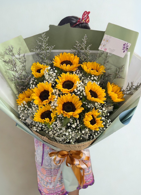 Golden sunflowers with baby's breath in sage green wrapping with golden ribbon - natural flower delivery Bangkok | DP FLOWERS BANGKOK