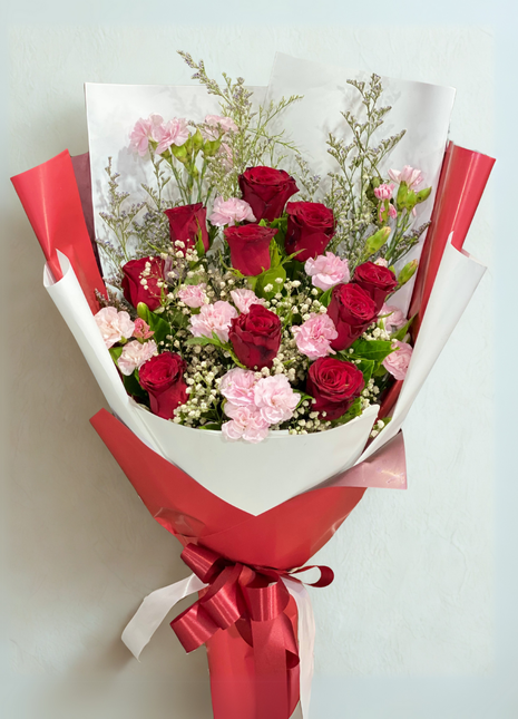 Red roses and pink carnations romantic bouquet wrapped in white and red paper with ribbons - Valentine flower delivery Bangkok | DP FLOWERS BANGKOK