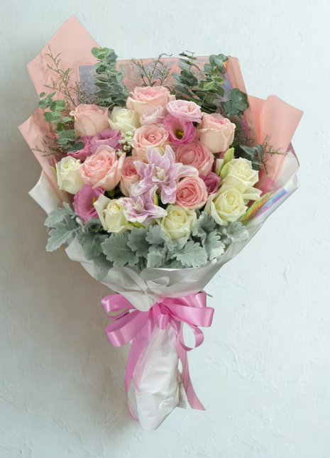 Sweet pastel roses and lisianthus bouquet in coral pink wrapping with pink ribbon - dreamy flower delivery Bangkok | DP FLOWERS BANGKOK