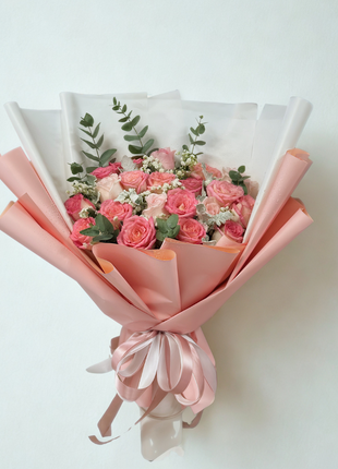 Elegant coral and pink roses bouquet with eucalyptus in white coral wrapping - fresh flower delivery Bangkok | DP FLOWERS BANGKOK