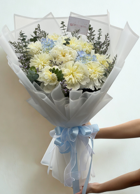Luxury ivory white peonies and blue hydrangeas bouquet with eucalyptus wrapped in premium white paper with sky blue satin ribbon - flower delivery Bangkok | DP FLOWERS BANGKOK