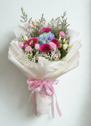 Romantic bouquet with fuchsia gerberas, blue hydrangeas and pink lisianthus wrapped in white ruffled paper with pink ribbon - dreamy flower delivery Bangkok | DP FLOWERS BANGKOK