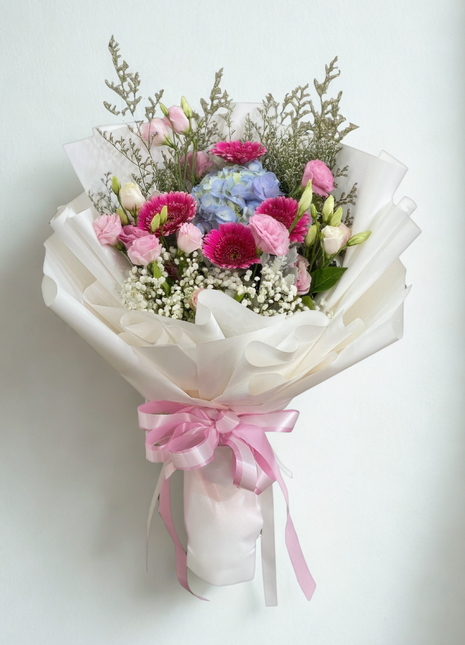 Romantic bouquet with fuchsia gerberas, blue hydrangeas and pink lisianthus wrapped in white ruffled paper with pink ribbon - dreamy flower delivery Bangkok | DP FLOWERS BANGKOK