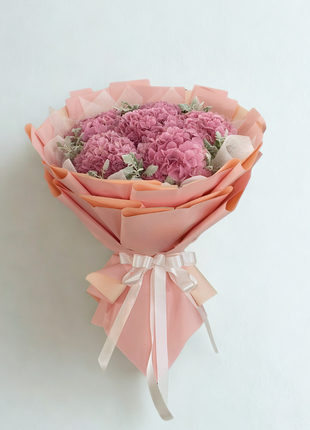 Sweet pink hydrangeas bouquet with dusty miller foliage wrapped in peachy pink paper with satin ribbon - appreciation delivery Bangkok | DP FLOWERS BANGKOK