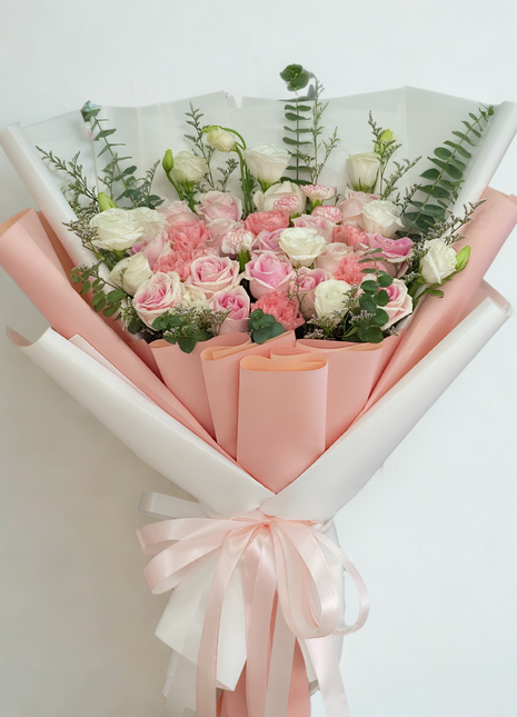 Elegant soft pink and white roses bouquet with carnations and lisianthus wrapped in double-layer pink and white paper with satin ribbons - luxury flower delivery Bangkok | DP FLOWERS BANGKOK