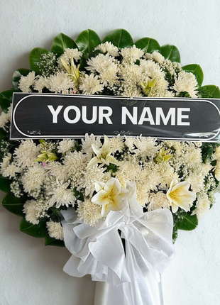 Pure white funeral wreath with lilies, chrysanthemums and personalized nameplate - elegant memorial flower delivery Bangkok | DP FLOWERS BANGKOK