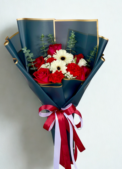 Luxurious deep red roses and white gerbera daisies bouquet wrapped in navy blue paper with gold trim and burgundy ribbons - premium flower delivery Bangkok | DP FLOWERS BANGKOK