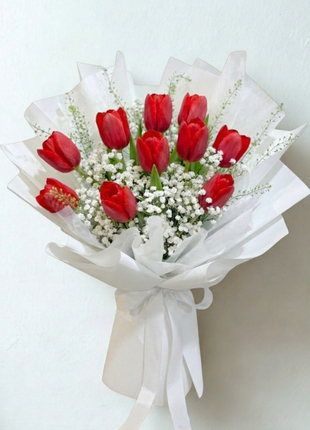 Bold red tulips bouquet with white baby's breath wrapped in crisp white paper with satin ribbon - romantic flower delivery Bangkok | DP FLOWERS BANGKOK