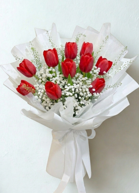 Bold red tulips bouquet with white baby's breath wrapped in crisp white paper with satin ribbon - romantic flower delivery Bangkok | DP FLOWERS BANGKOK