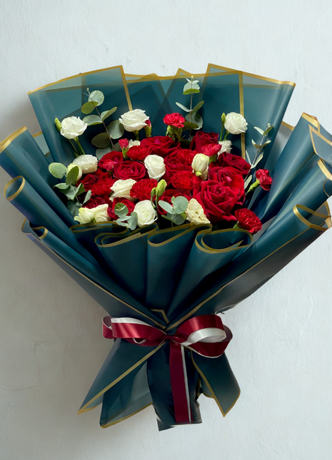 Luxury red and white roses bouquet wrapped in emerald green paper with gold trim and burgundy ribbon - romantic flower delivery Bangkok | DP FLOWERS BANGKOK