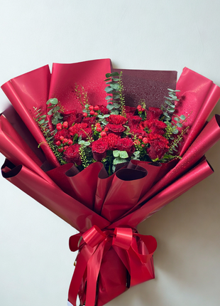 Dramatic deep red roses and carnations bouquet with berries wrapped in crimson paper - passionate flower delivery Bangkok | DP FLOWERS BANGKOK