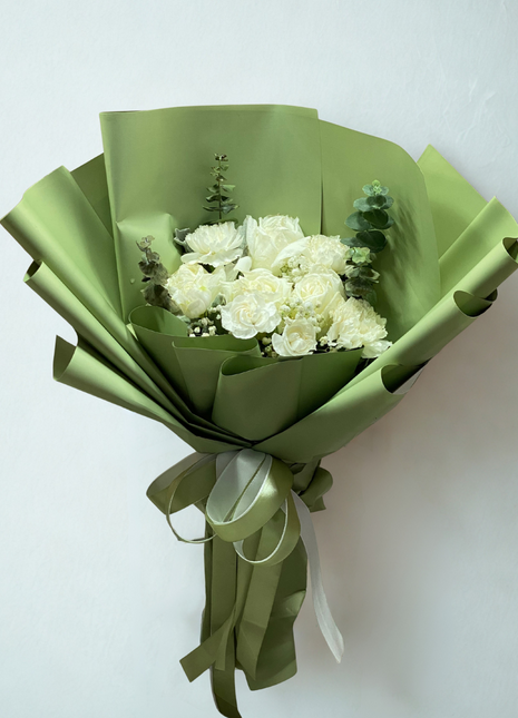 Elegant white roses and white carnations bouquet with eucalyptus wrapped in sage green paper - peaceful flower delivery Bangkok | DP FLOWERS BANGKOK