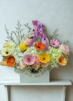 Colorful gerbera daisies and roses arrangement in decorative gift box with purple ribbon - flower delivery Bangkok | DP FLOWERS BANGKOK