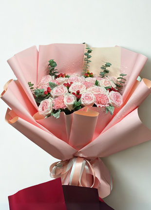 Sweet pink roses and carnations bouquet with red berries wrapped in coral-pink paper - charming flower delivery Bangkok | DP FLOWERS BANGKOK