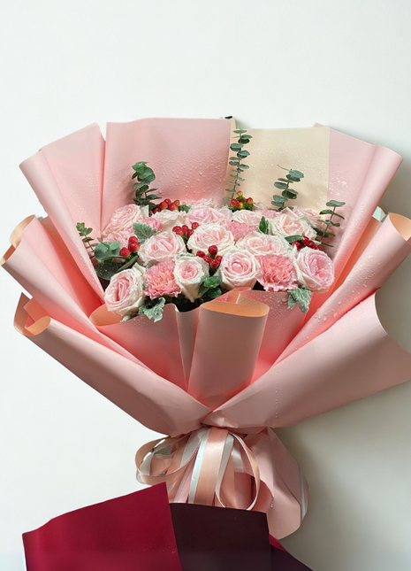 Sweet pink roses and carnations bouquet with red berries wrapped in coral-pink paper - charming flower delivery Bangkok | DP FLOWERS BANGKOK