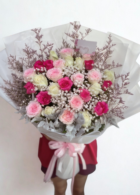 Elegant white, pink and fuchsia roses bouquet with baby's breath wrapped in translucent paper - romantic flower delivery Bangkok | DP FLOWERS BANGKOK