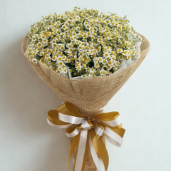 Abundant white and yellow daisy bouquet wrapped in natural burlap with golden ribbon - fresh cheerful flower delivery Bangkok | DP FLOWERS BANGKOK