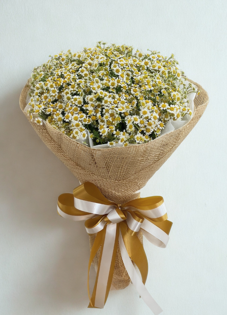 Abundant white and yellow daisy bouquet wrapped in natural burlap with golden ribbon - fresh cheerful flower delivery Bangkok | DP FLOWERS BANGKOK