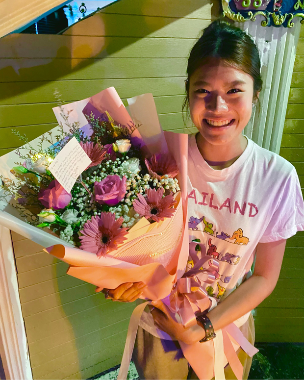 Happy woman holding a beautiful bouquet from DP FLOWERS BANGKOK – real customer review, surprised with flower delivery