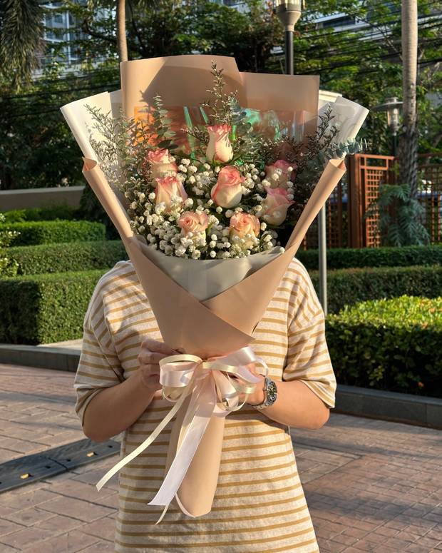 Happy woman holding a beautiful bouquet from DP FLOWERS BANGKOK – real customer review, surprised with flower delivery