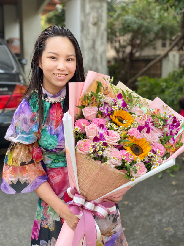 Happy woman holding a beautiful bouquet from DP FLOWERS BANGKOK – real customer review, surprised with flower delivery